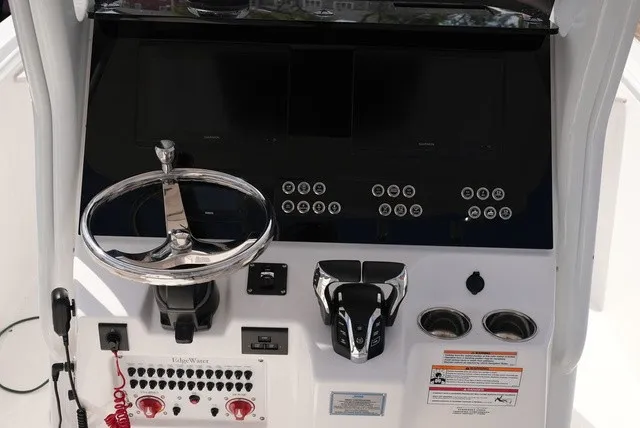 Slide: The Image of The image shows the helm of a 2024 Edgewater 262CC boat with modern controls. - 15