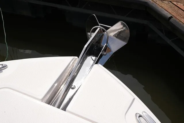 Slide: The Image of The bow of a 2024 Edgewater 262CC featuring a shiny anchor and windlass. - 23