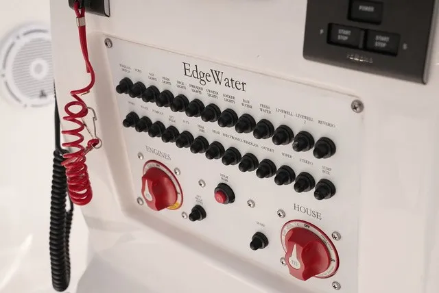 Slide: The Image of Control panel of an Edgewater 262CC boat with various switches and control knobs. - 16