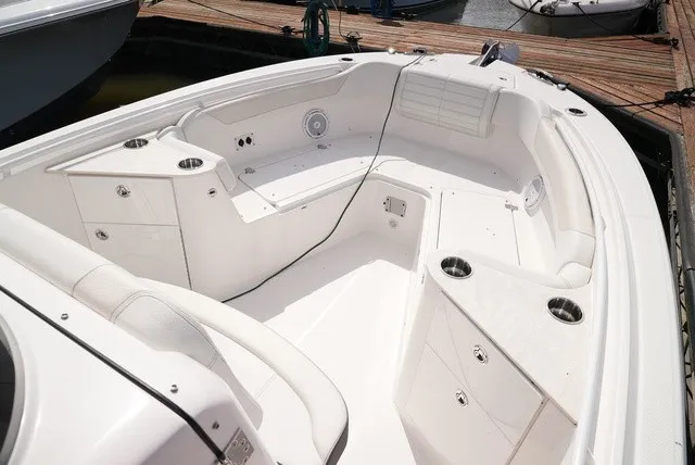 Slide: The Image of The image shows the spacious, white cockpit of an Edgewater 262CC boat docked at a pier. - 19