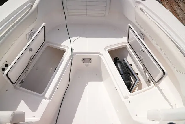 Slide: The Image of The image shows the bow area of an Edgewater 262CC boat with open storage compartments. - 22