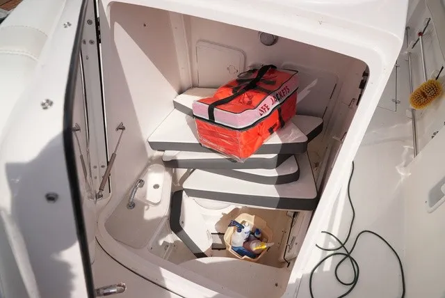 Slide: The Image of The image shows the interior of an Edgewater 262CC boat with seat cushions and a life ring. - 21