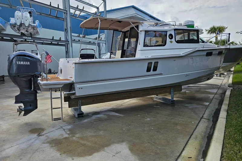 Slide: The Image of 2025 Ranger Tugs R-27 boat with Yamaha outboard motor on display. - 2