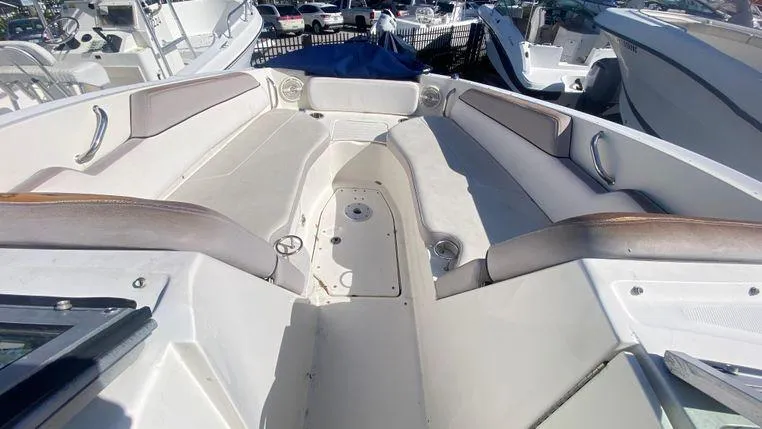 Slide: The Image of 2011 Sea Ray 300 Sundeck boat interior with spacious seating and cup holders. - 19