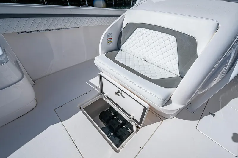 Slide: The Image of 2019 Intrepid 407 Nomad FE boat seat with storage compartment open. - 11