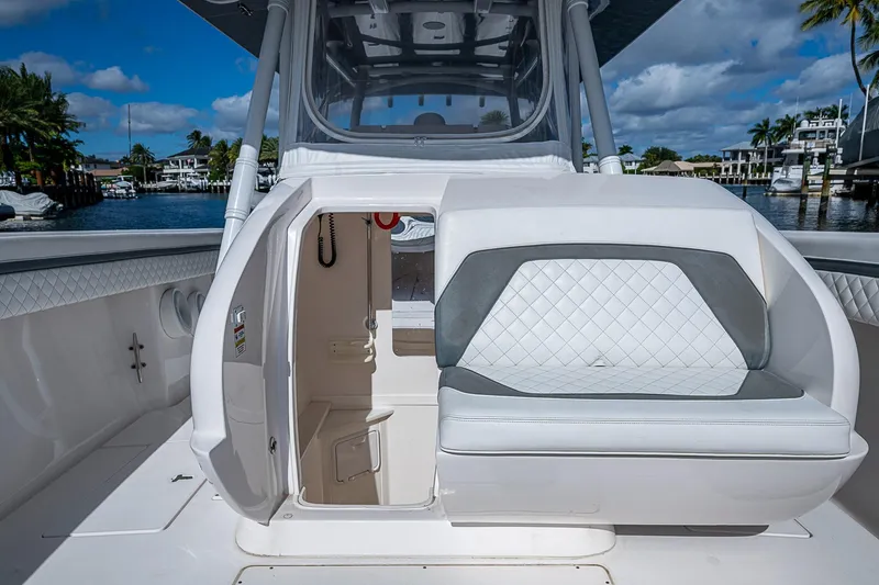 Slide: The Image of 2019 Intrepid 407 Nomad FE boat interior with seating and open cabin door. - 12