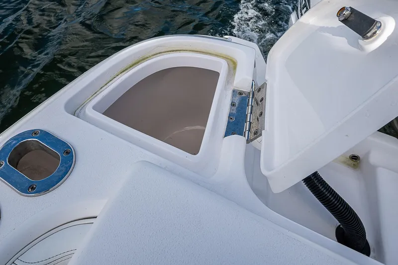 Slide: The Image of Open storage compartment on 2019 Intrepid 407 Nomad FE boat, near water surface. - 16
