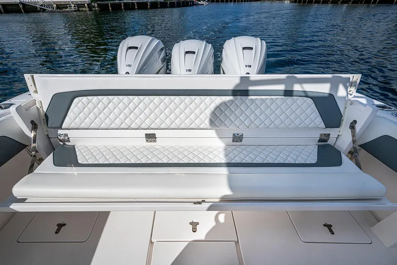 Slide: The Image of 2019 Intrepid 407 Nomad FE boat with cushioned seating and triple Yamaha V8 engines. - 18