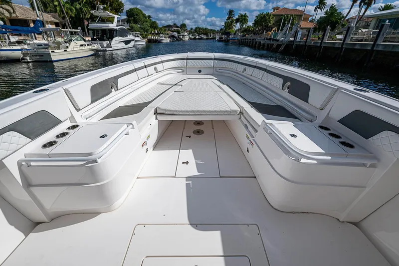Slide: The Image of 2019 Intrepid 407 Nomad FE boat interior with spacious seating and cup holders. - 2