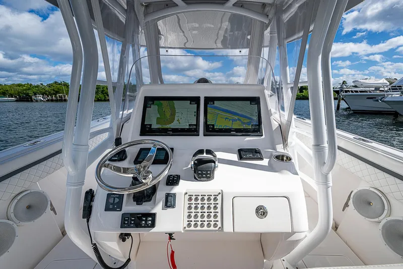 Slide: The Image of 2019 Intrepid 407 Nomad FE boat helm with dual navigation screens and steering wheel. - 29