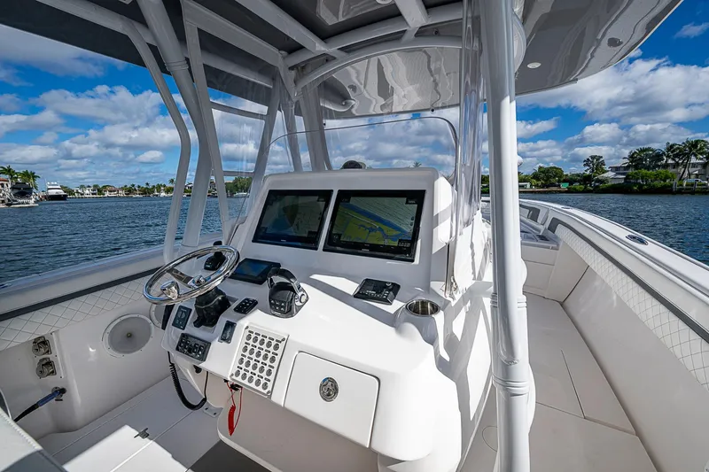 Slide: The Image of 2019 Intrepid 407 Nomad FE boat cockpit with navigation screens and steering wheel. - 30