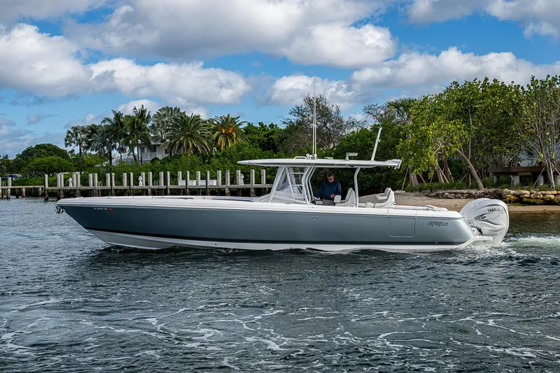 Slide: The Image of 2019 Intrepid 407 Nomad FE boat cruising on a scenic waterway. - 36