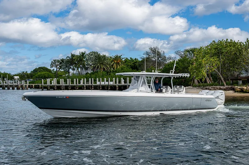 Slide: The Image of 2019 Intrepid 407 Nomad FE boat cruising on a scenic waterway. - 37