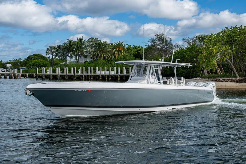 Slide: The Image of 2019 Intrepid 407 Nomad FE boat cruising near a tropical shoreline. - 38