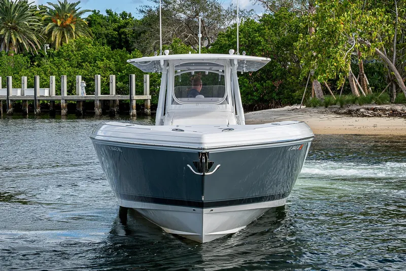 Slide: The Image of 2019 Intrepid 407 Nomad FE boat cruising near a tropical shoreline. - 39