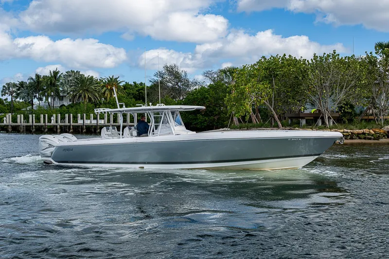 Slide: The Image of 2019 Intrepid 407 Nomad FE boat cruising on a scenic waterway. - 42