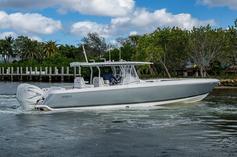 Slide: The Image of 2019 Intrepid 407 Nomad FE boat cruising on a scenic waterway. - 45