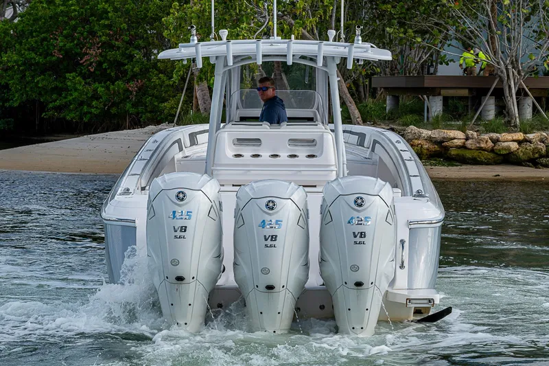 Slide: The Image of 2019 Intrepid 407 Nomad FE boat with triple Yamaha 425 V8 engines on water. - 49