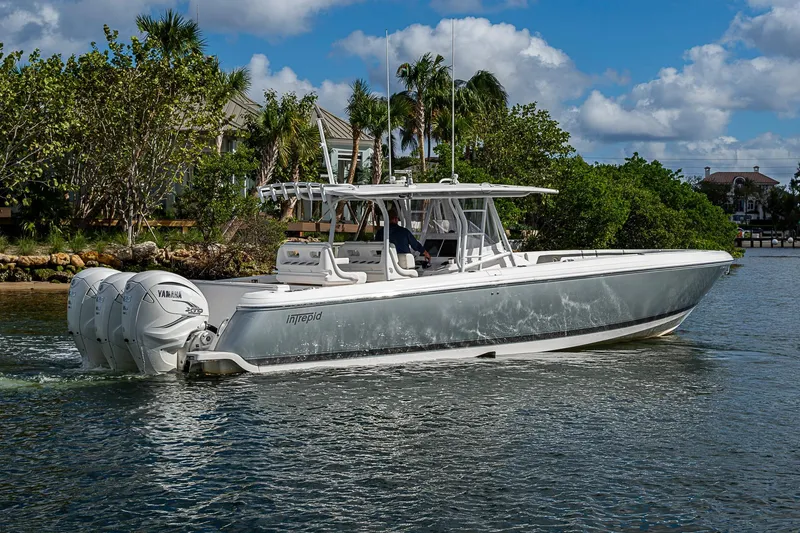 Slide: The Image of 2019 Intrepid 407 Nomad FE boat cruising on a scenic waterway. - 52