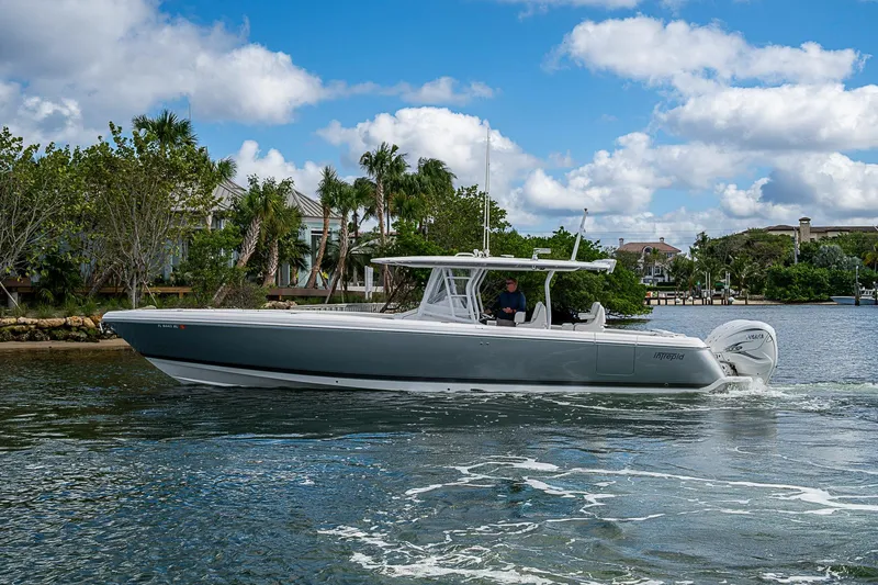 Slide: The Image of 2019 Intrepid 407 Nomad FE boat cruising on a scenic waterway. - 58