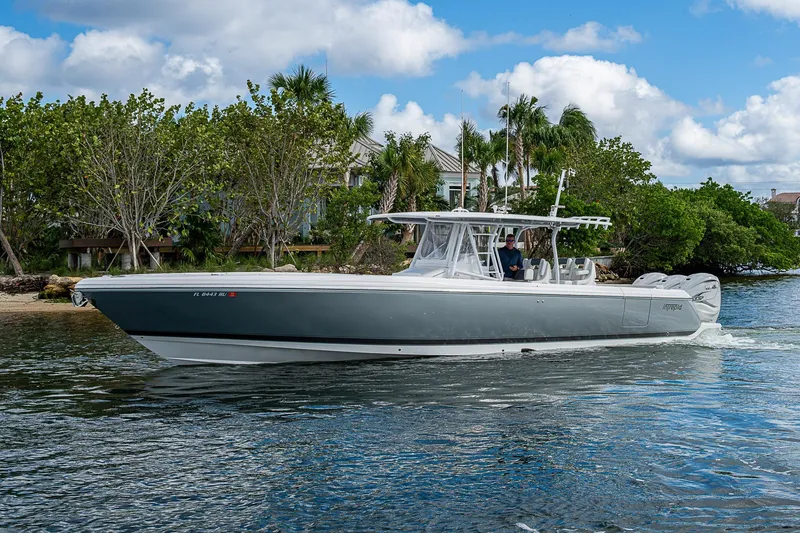 Slide: The Image of 2019 Intrepid 407 Nomad FE boat cruising on a scenic waterway. - 60