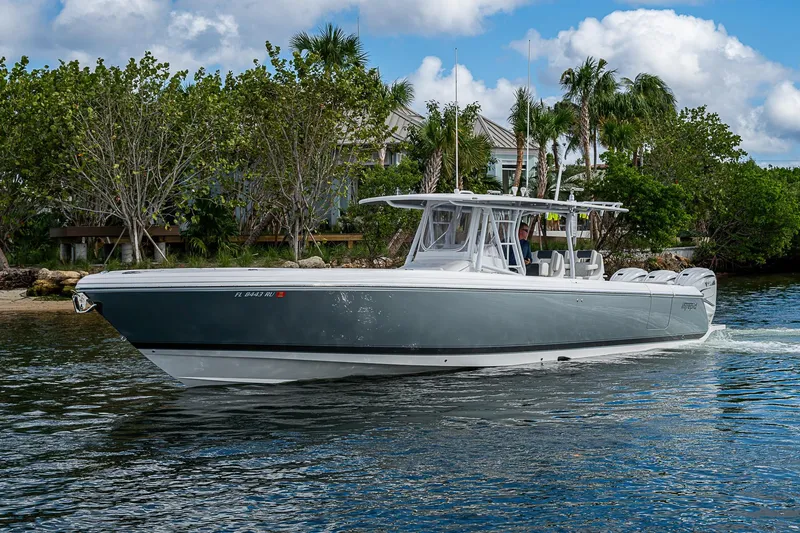 Slide: The Image of 2019 Intrepid 407 Nomad FE boat cruising on a scenic waterway. - 61