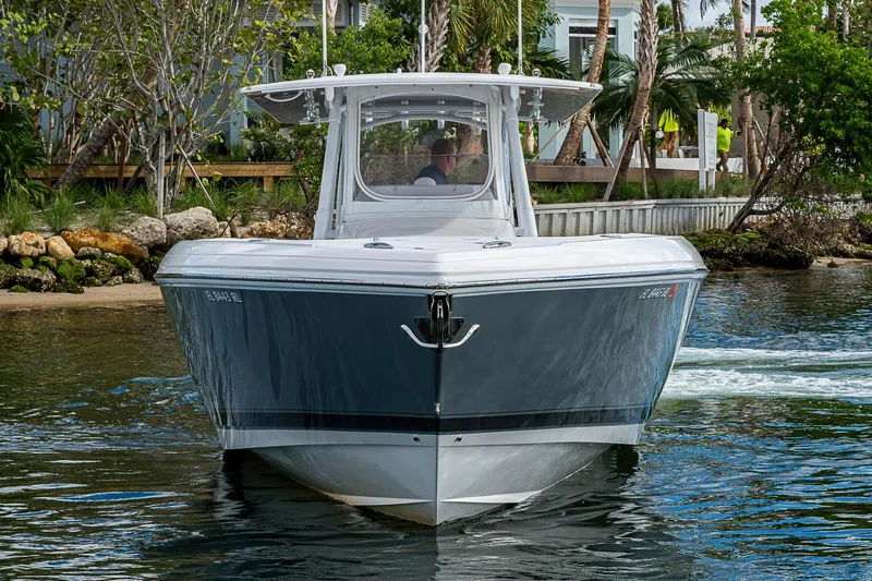 Slide: The Image of 2019 Intrepid 407 Nomad FE boat cruising near a tropical shoreline. - 62