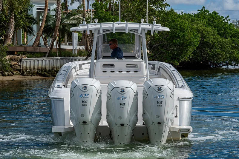 Slide: The Image of 2019 Intrepid 407 Nomad FE boat with triple Yamaha V8 engines on water. - 68