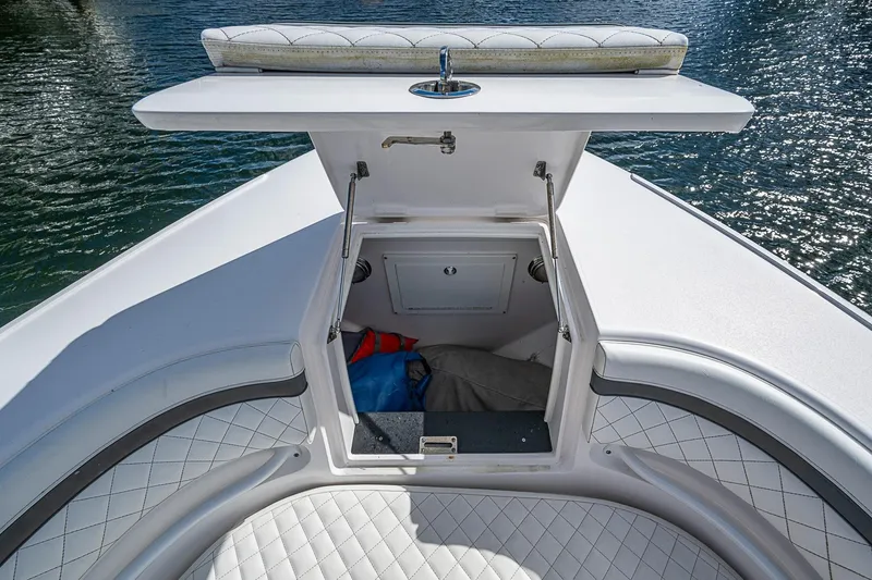 Slide: The Image of 2019 Intrepid 407 Nomad FE boat with open storage compartment and cushioned seating. - 7