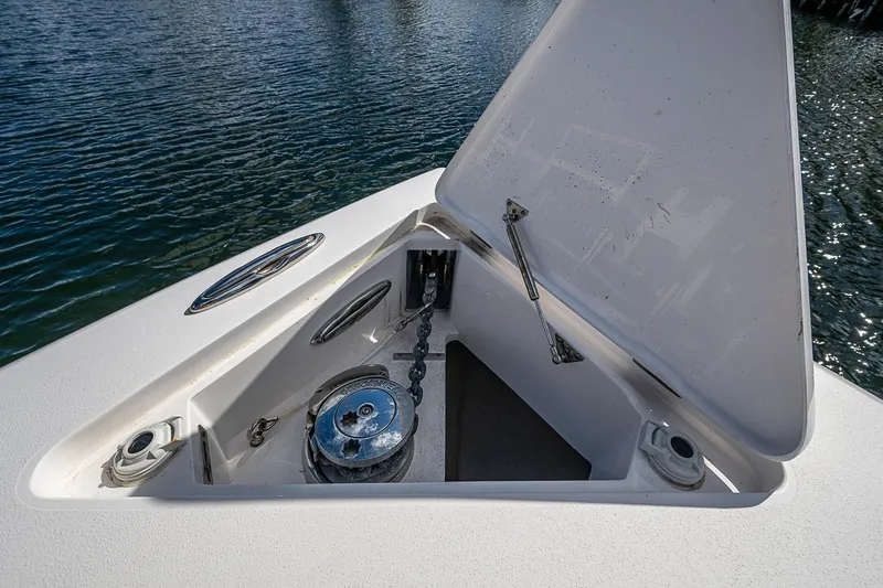 Slide: The Image of 2019 Intrepid 407 Nomad FE anchor compartment with open hatch, showcasing marine hardware. - 8