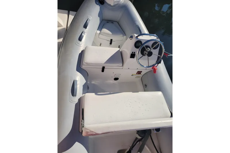 Slide: The Image of 2017 AB Inflatables Mares 10 VSX boat docked on calm water. - 2