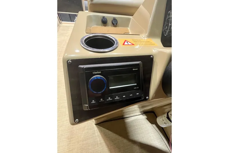 Slide: The Image of 2022 Harris Cruiser 230 dashboard with Clarion Bluetooth stereo system. - 12