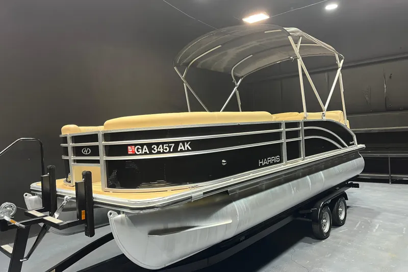 Slide: The Image of 2022 Harris Cruiser 230 pontoon boat on trailer in indoor setting. - 2