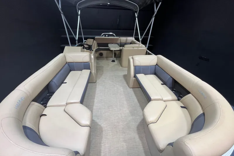 Slide: The Image of 2022 Harris Cruiser 230 pontoon boat interior with beige seating and canopy. - 6