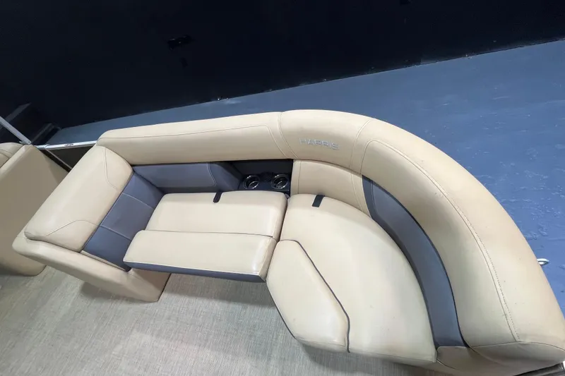 Slide: The Image of Luxurious seating on 2022 Harris Cruiser 230 boat, featuring beige and gray upholstery. - 7