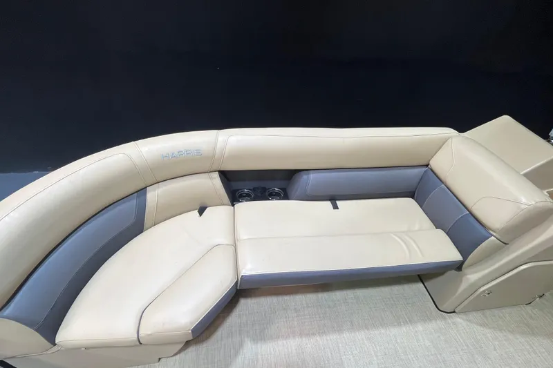 Slide: The Image of 2022 Harris Cruiser 230 boat interior with beige and gray seating. - 8