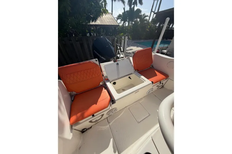 Slide: The Image of 2022 Trophy 2203 Center Console boat with orange seating and storage compartment. - 11