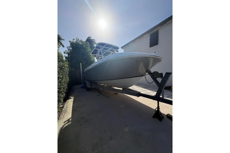 Slide: The Image of 2022 Trophy 2203 Center Console boat on trailer under bright sun. - 4