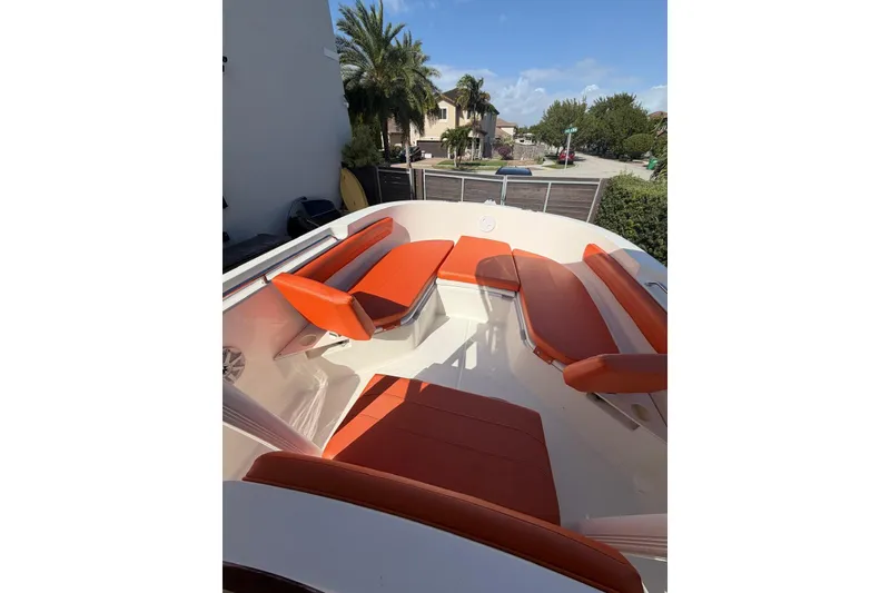 Slide: The Image of 2022 Trophy 2203 Center Console boat with orange seating, docked in a residential area. - 9