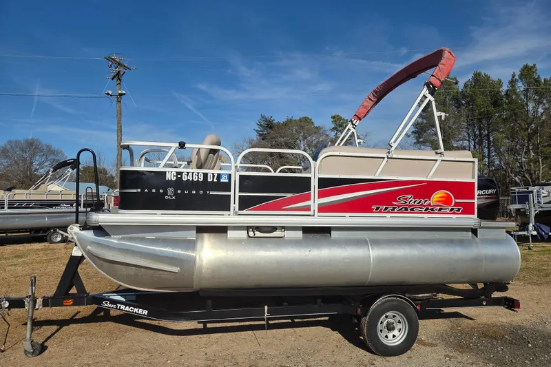 The Image of 2014 Sun Tracker Bass Buggy 16 DLX pontoon boat on trailer, outdoors. - 0