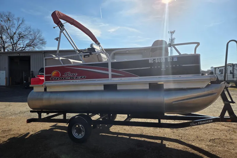 Slide: The Image of 2014 Sun Tracker Bass Buggy 16 DLX pontoon boat on trailer, sunny day. - 3