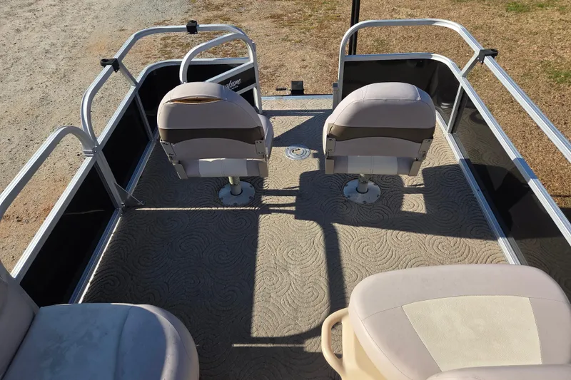 Slide: The Image of 2014 Sun Tracker Bass Buggy 16 DLX pontoon boat interior with seating and railing. - 6