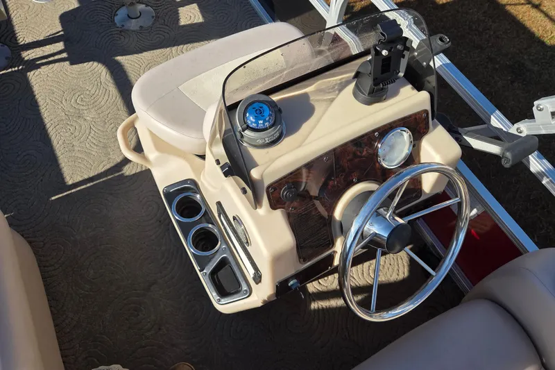Slide: The Image of 2014 Sun Tracker Bass Buggy 16 DLX boat console with steering wheel and cup holders. - 8