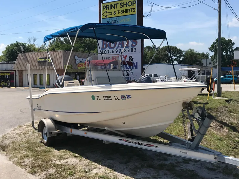 Slide: The Image of 2001 Scout 185 Sportfish on trailer outside print shop. - 2