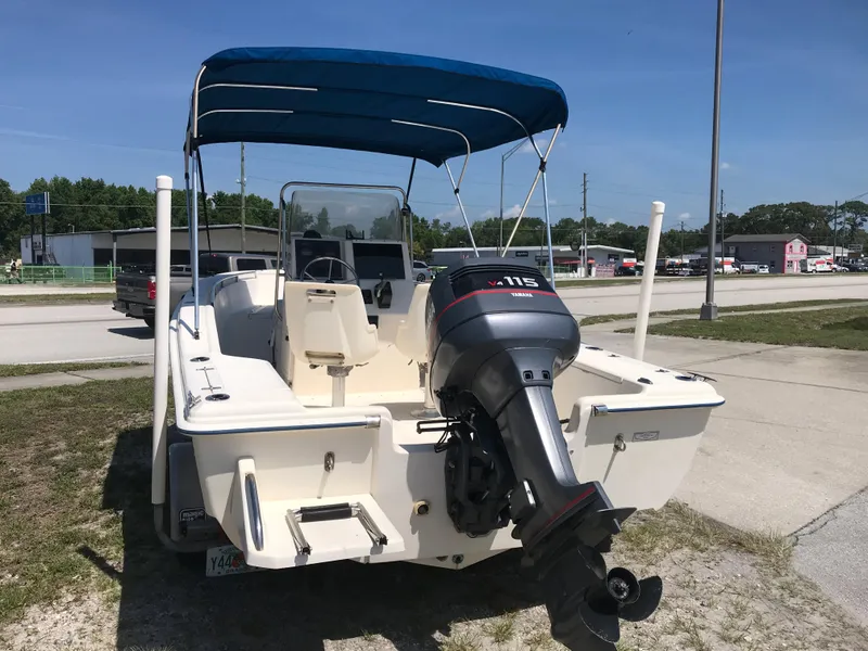 Slide: The Image of 2001 Scout 185 Sportfish with outboard motor and blue sunshade. - 7