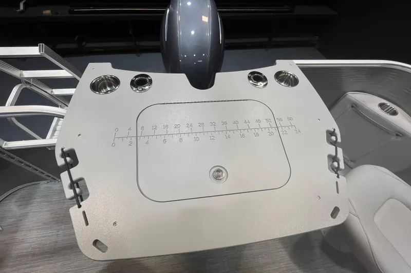 Slide: The Image of 2023 Bennington 22 FS boat console with cup holders and measurement markings. - 12