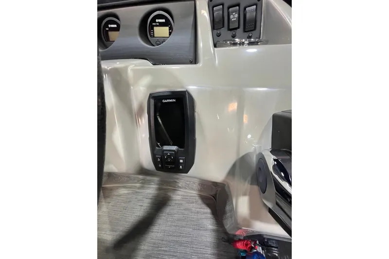 Slide: The Image of 2023 Bennington 22 FS dashboard featuring Garmin navigation system and Yamaha gauges. - 14