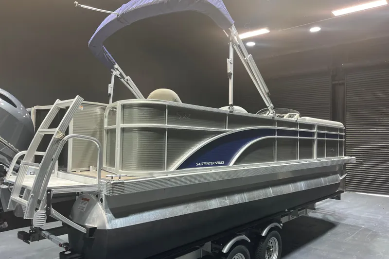Slide: The Image of 2023 Bennington 22 FS pontoon boat in a showroom, featuring a sleek design and sturdy build. - 4