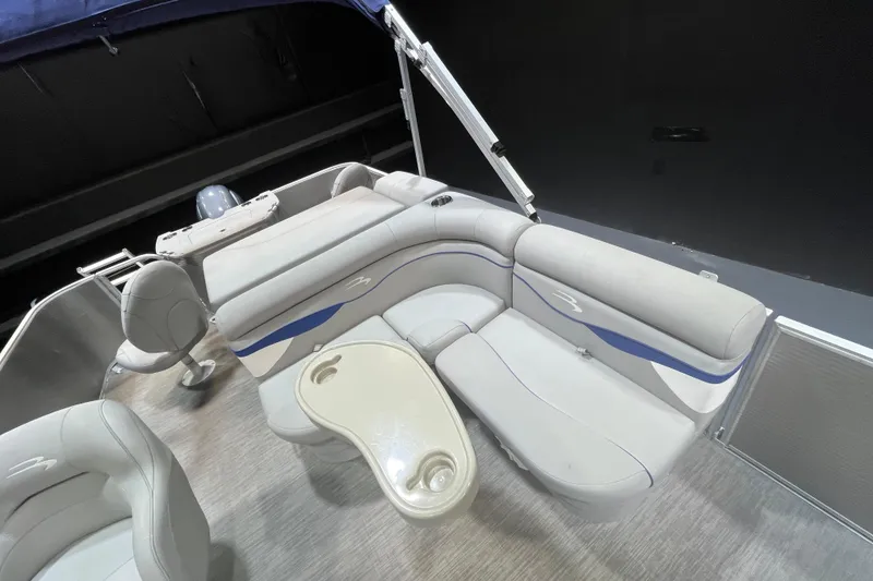 Slide: The Image of 2023 Bennington 22 FS pontoon boat interior with plush seating and table. - 8