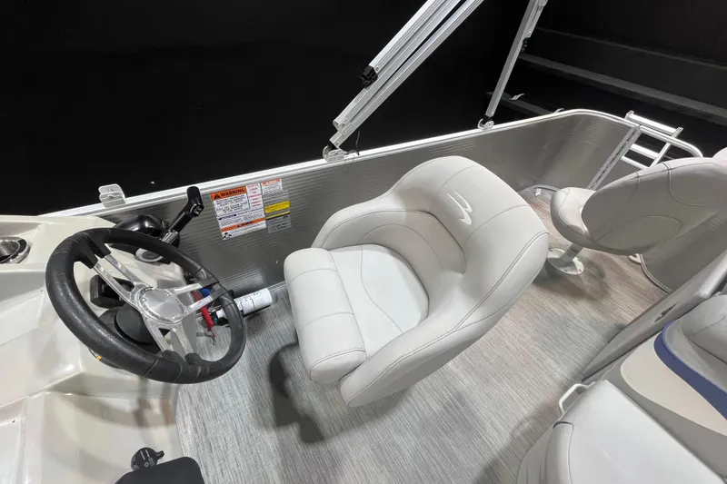 Slide: The Image of 2023 Bennington 22 FS boat interior with steering wheel and plush seating. - 9